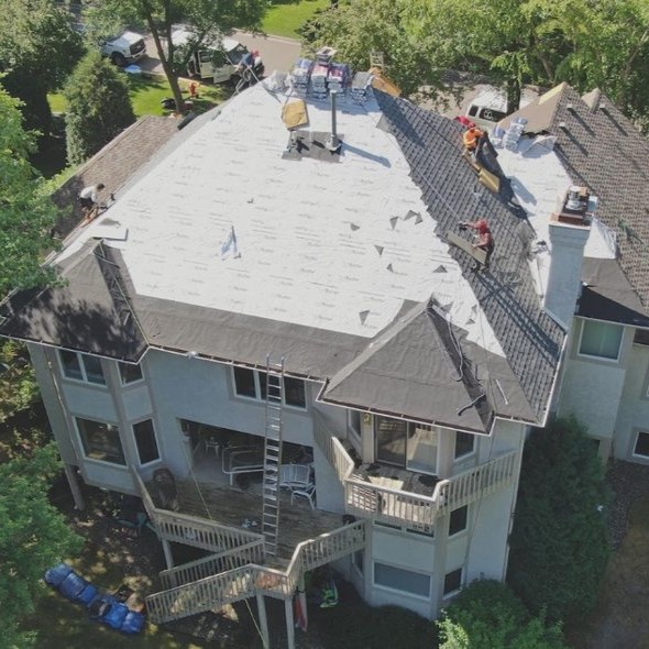 White home with newly installed exrterior and roofing by Rooster Exteriors